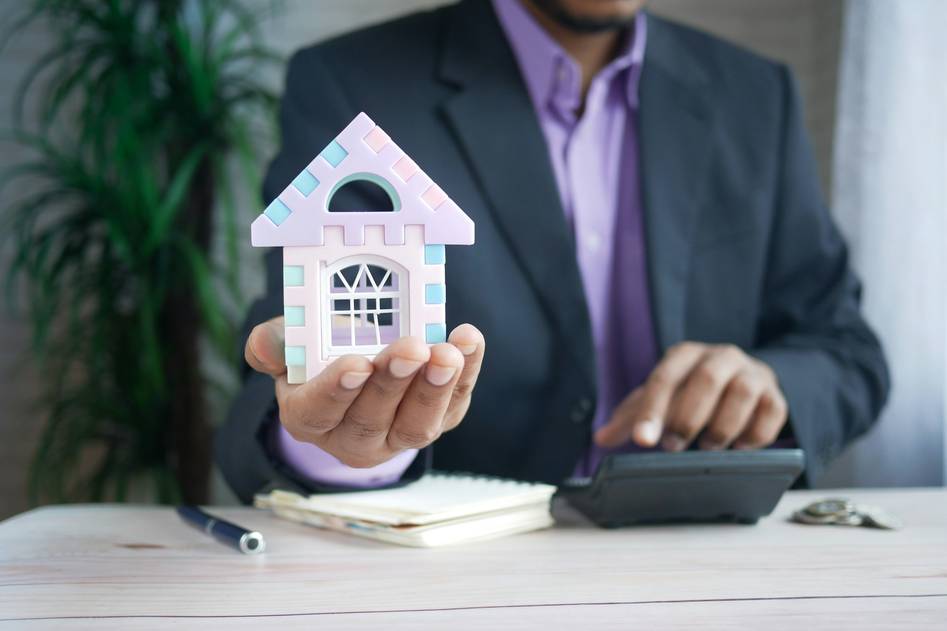 Hail-damaged roof with protective insurance documents on a calm desk