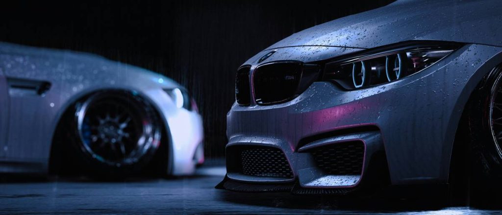 two cars parked side by side in a garage
